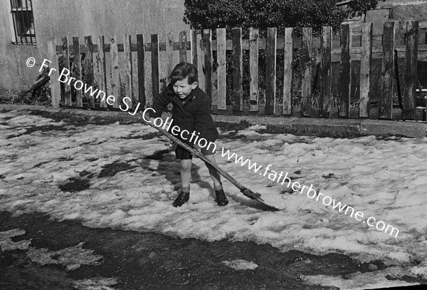 CHILD PLAYING WITH SHOVEL